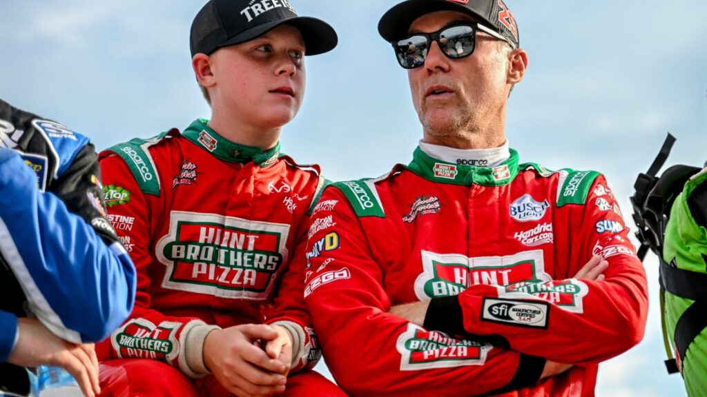 Former NASCAR Cup Series champion Kevin Harvick, center, right, and his son Keelan, 13, look on before the two raced in the 13th annual Masters of the Pros 200 race on Wednesday,