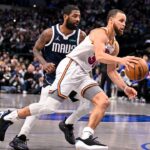 Golden State Warriors guard Stephen Curry (30) and Dallas Mavericks guard Kyrie Irving (11) in action during the game between the Dallas Mavericks and the Golden State Warriors at the American Airlines Center.