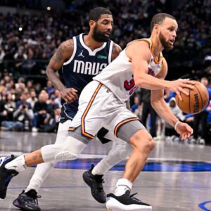 Golden State Warriors guard Stephen Curry (30) and Dallas Mavericks guard Kyrie Irving (11) in action during the game between the Dallas Mavericks and the Golden State Warriors at the American Airlines Center.