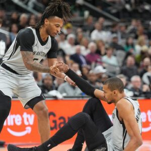 San Antonio Spurs guard Stephon Castle (5) helps up forward Victor Wembanyama (1) in the first half against the Dallas Mavericks at Frost Bank Center