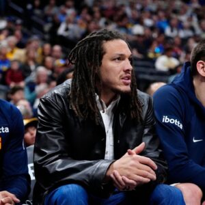 Mar 1, 2026; Denver, Colorado, USA; Denver Nuggets guard Jamal Murray (27) and forward Aaron Gordon (32) and center Nikola Jokic (15) on the bench during the second quarter against the Minnesota Timberwolves at Ball Arena. Mandatory Credit: Ron Chenoy-Imagn Images