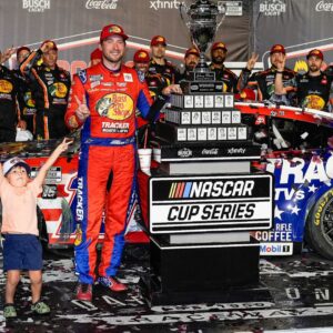 Aug 31, 2025; Darlington, South Carolina, USA; NASCAR Cup Series driver Chase Briscoe (19) celebrates his win with his son Brooks at the Cookouts Southern 500 at Darlington Raceway.