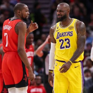 Houston Rockets forward Kevin Durant (7) talks with Los Angeles Lakers forward LeBron James (23) on the court during the second quarter at Toyota Center.