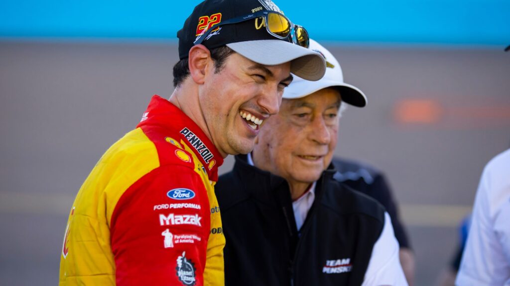 Nov 6, 2022; Avondale, Arizona, USA; NASCAR Cup Series driver Joey Logano celebrates with team owner Roger Penske after winning the Cup Championship at Phoenix Raceway