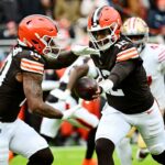 Cleveland Browns quarterback Shedeur Sanders (12) hands off the ball to Cleveland Browns running back Quinshon Judkins (10) during the first half against the San Francisco 49ers at Huntington Bank Field.
