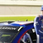 Kyle Larson waits by his car before the NASCAR Cup Series Duel during Speedweek, Thursday, Feb. 12, 2026.