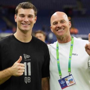 Indiana quarterback Fernando Mendoza (QB11) poses with former Seattle Seahawks quarterback Matt Hasselbeck during the NFL Scouting Combine at Lucas Oil Stadium.