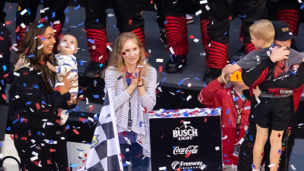 Alexa Reddick holding Rookie after Tyler Reddick's Daytona win