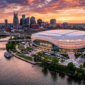 Aerial view of Nashville's new enclosed NFL stadium on Cumberland River at sunset with city skyline