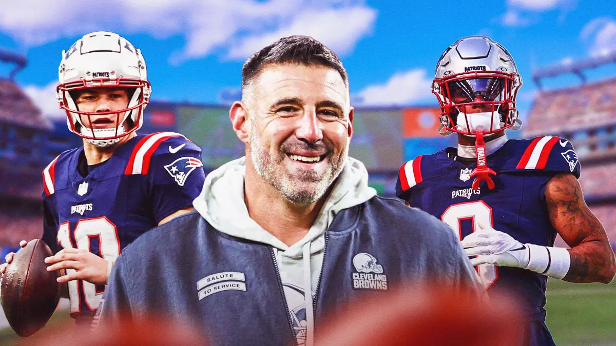 Pat Vrabel smiling in front of New England Patriots players and a stadium