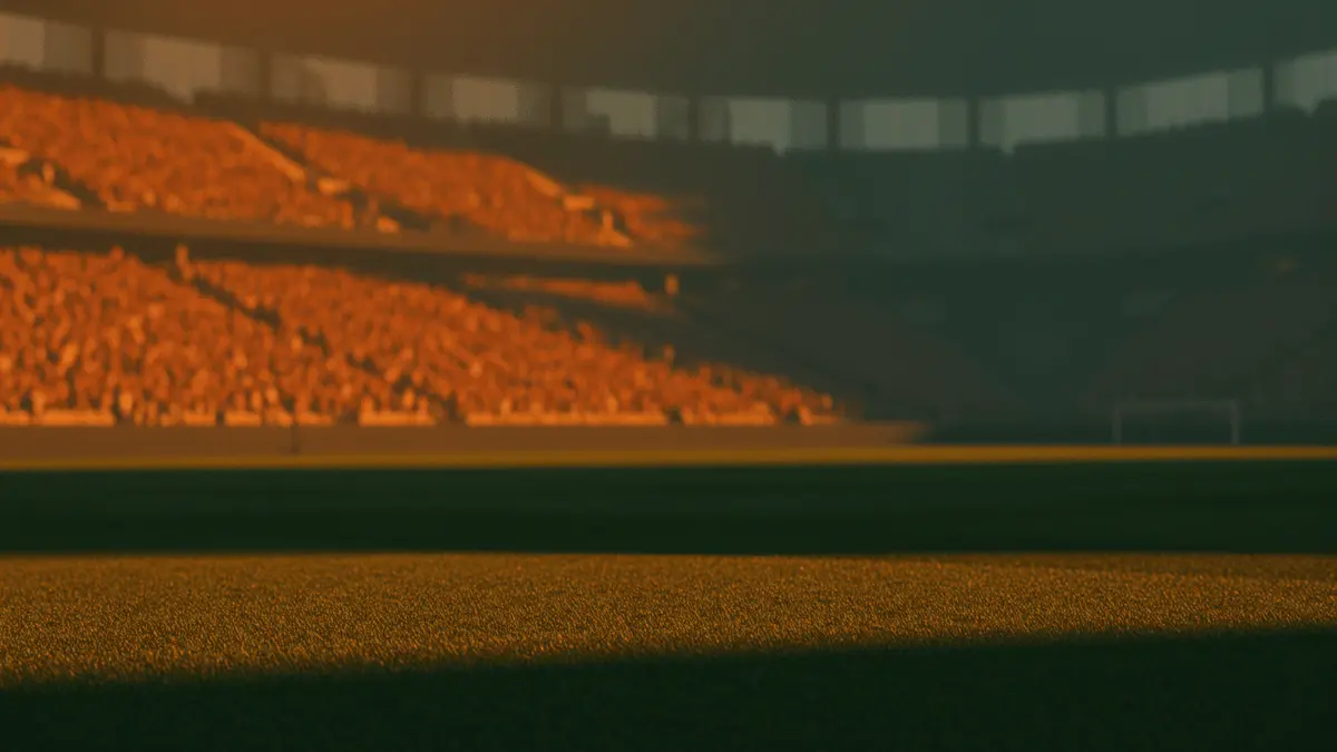 Floodlit stadium at golden-hour kick-off with packed stands, dramatic shadows on pristine pitch, no players visible.
