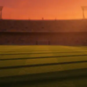 Floodlit stadium pitch at golden-hour with empty turf, packed stands, and national flag colour atmosphere.