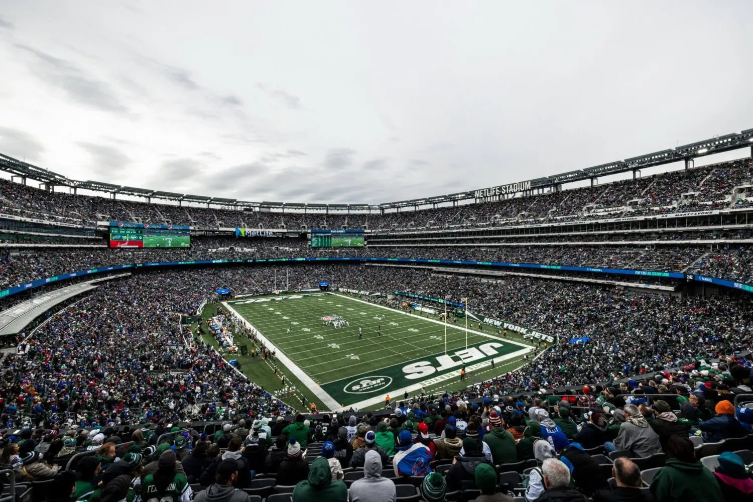 Packed MetLife Stadium during a New York Jets home game with a football field.