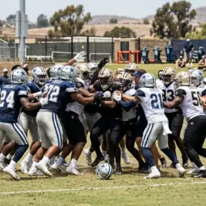 Dallas Cowboys and New Orleans Saints players are separated during a chaotic joint practice scrum.