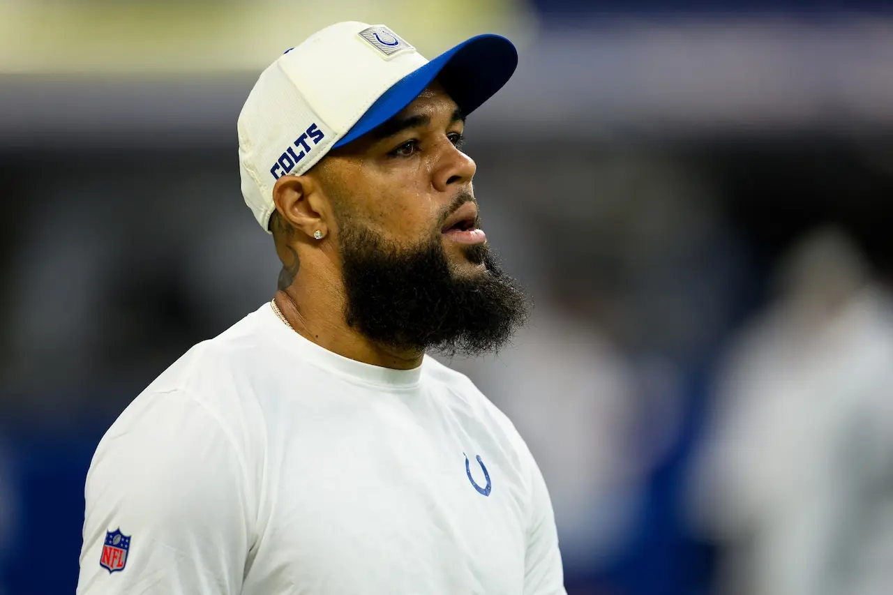 Keenan Allen wearing a white Indianapolis Colts hat and shirt on the field