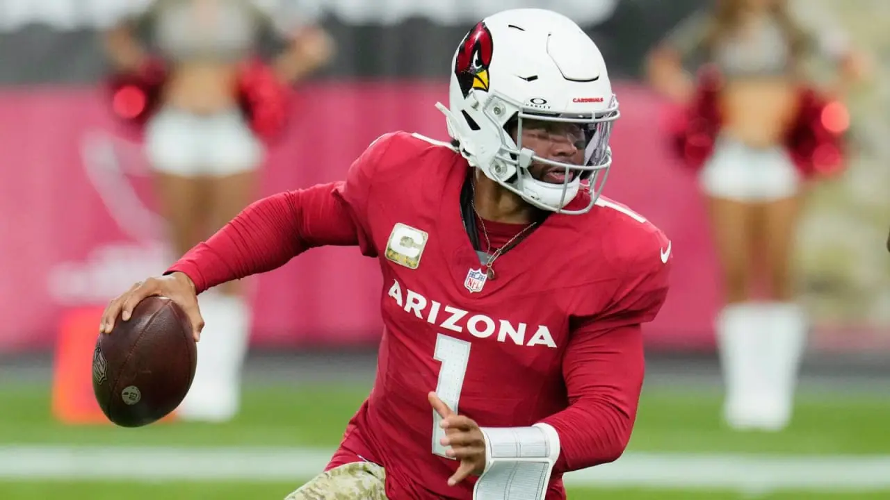 Kyler Murray in an Arizona Cardinals uniform holding a football during a game