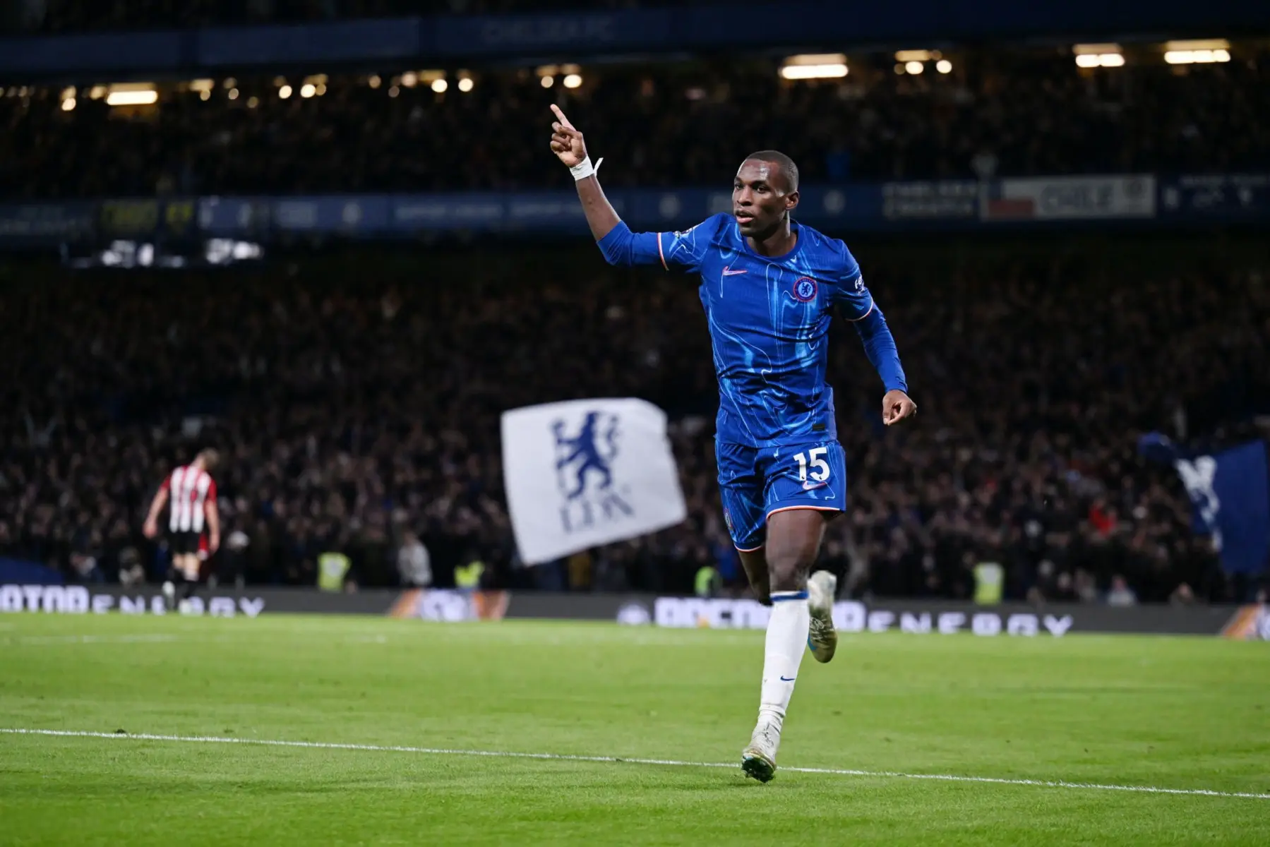 Nicolas Jackson celebrating a goal for Chelsea FC during a match, wearing a blue home kit with number 15.