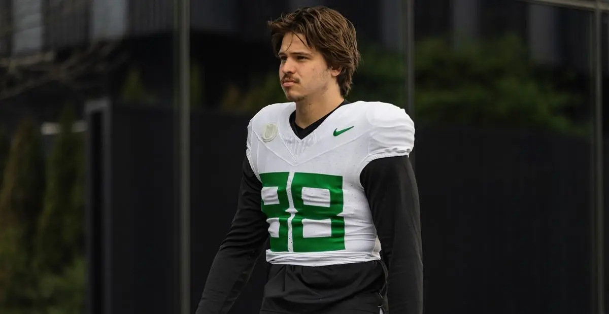 Oregon Ducks football player Patrick Herbert in a white and green practice jersey